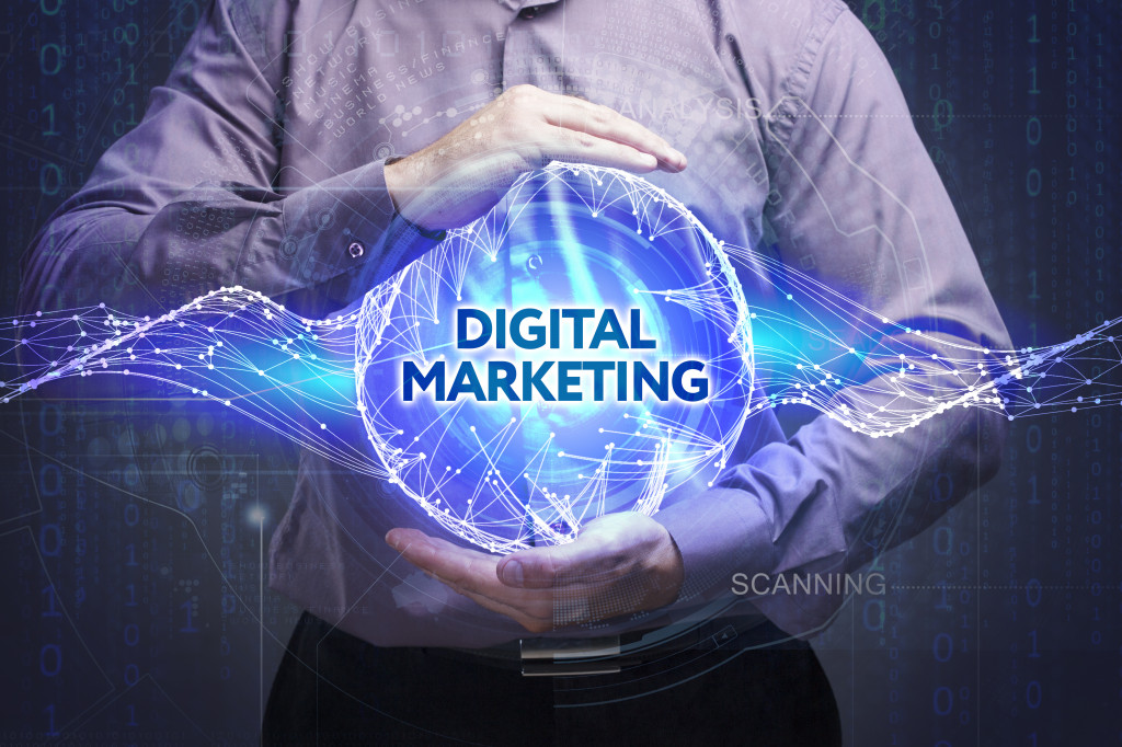 man holding a blue hologram of digital marketing