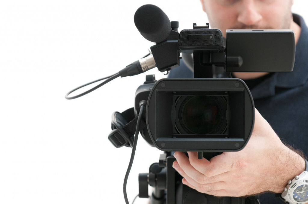 Cameraman creating video content using a professional video camera.